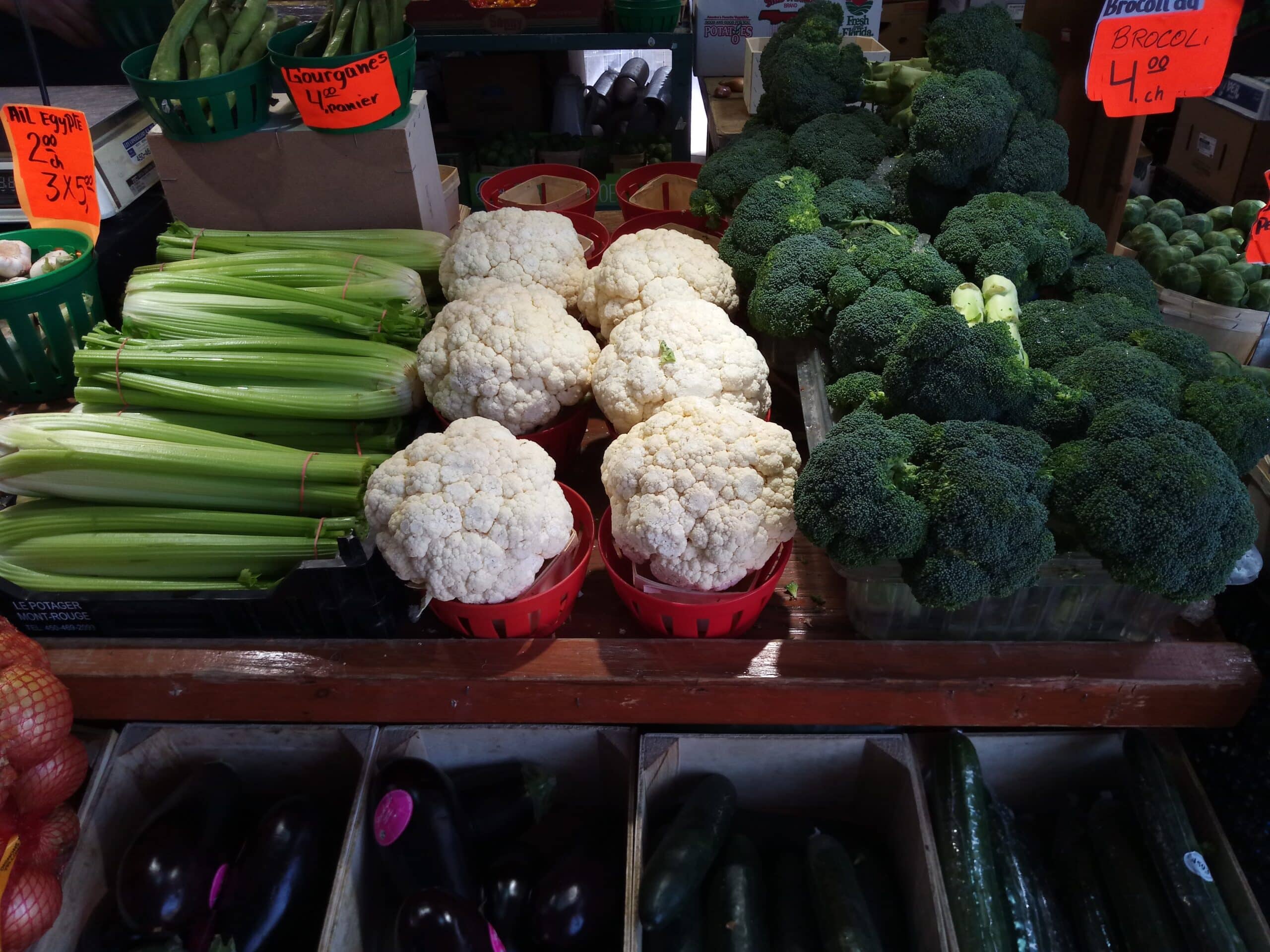 This local farmer's market vendor sells fresh broccoli  and cauliflower as well as many other vegetables.  