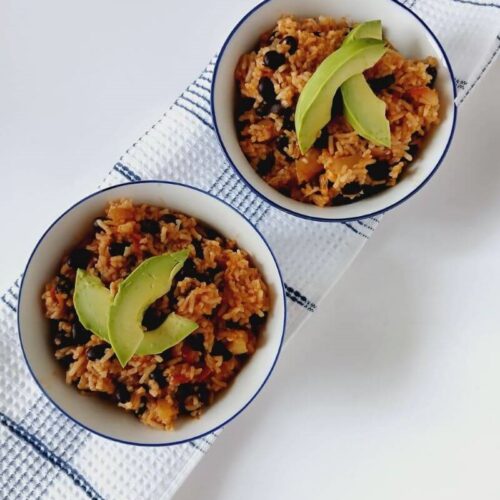 Here are side by side bowls of the vegan taco rice that happens to be a fast, filling weeknight dinner!